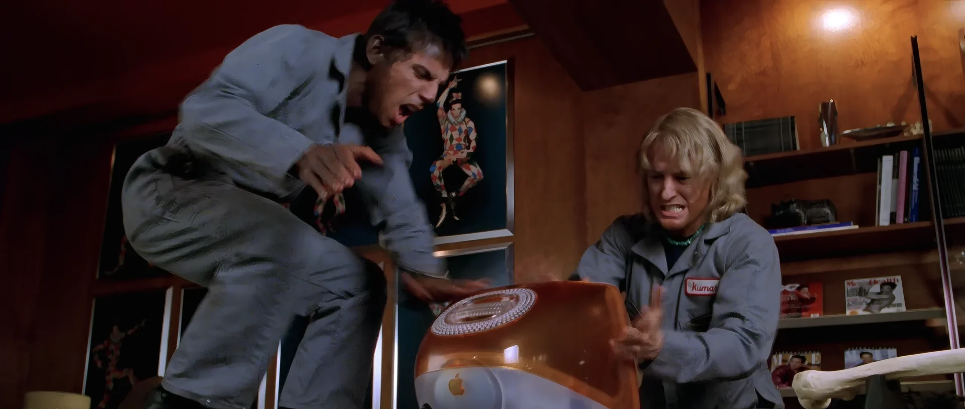Derek and Hansel slapping an orange iMac, trying to get the files out of it.